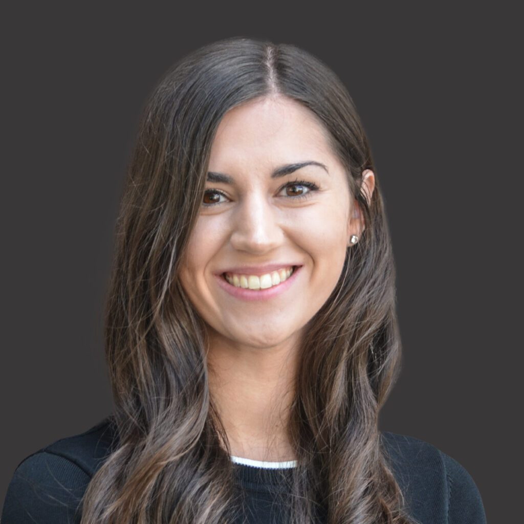 a professional headshot of karolyn stasny with a gray background